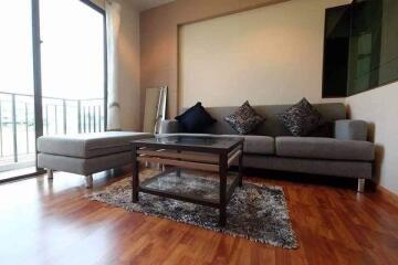 Modern living room with grey sofa and glass coffee table