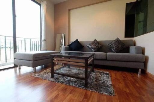 Modern living room with grey sofa and glass coffee table