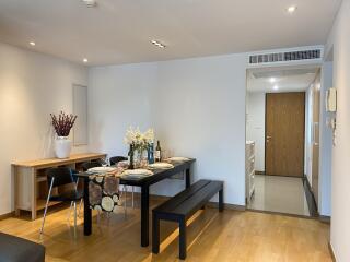 Modern furnished dining area with table, chairs, and decorations