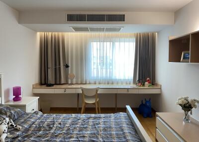 Well-lit bedroom with study desk