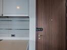 Modern kitchen with wooden door and white cabinets