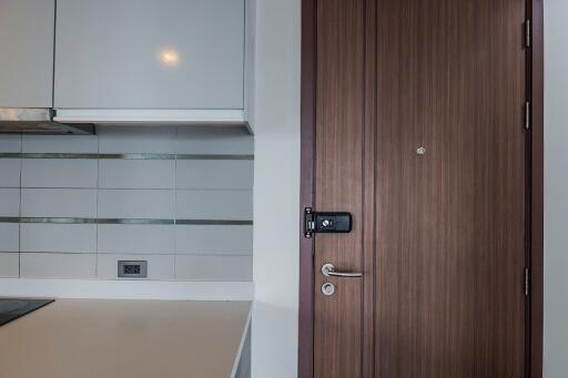 Modern kitchen with wooden door and white cabinets