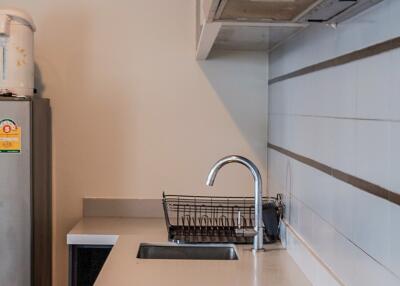 Modern kitchen with stovetops, sink, and cupboard