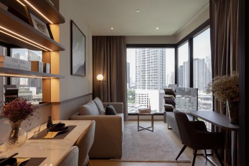 Modern living room with large windows, a sofa, table, and desk area.