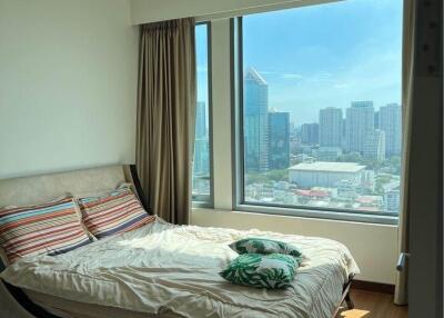 Bedroom with a large window and city view