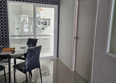 Modern dining area with a view into the kitchen