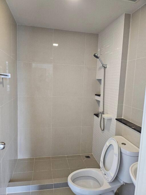 Modern bathroom with shower area and toilet