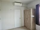 Bedroom with wardrobe and air conditioner