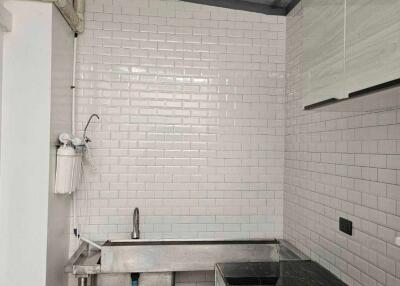 Modern kitchen with tile backsplash and stainless steel sink