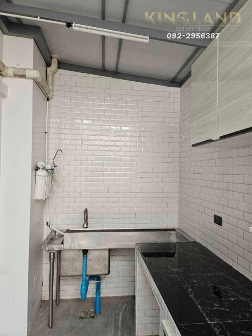 Modern kitchen with tile backsplash and stainless steel sink