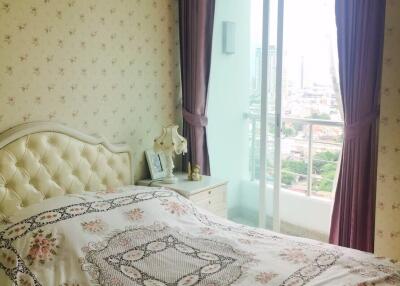 Elegantly decorated bedroom with chandelier and large window