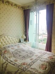 Elegantly decorated bedroom with chandelier and large window