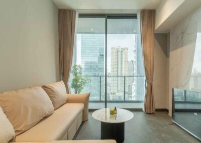 Modern living room with glass doors and city view