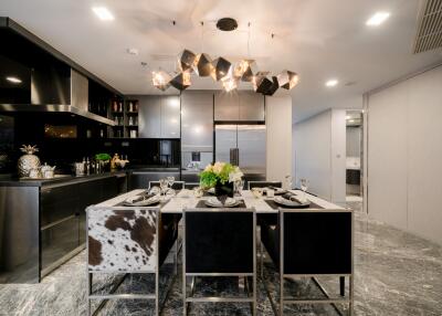 Modern kitchen with dining area featuring a stylish chandelier