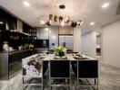 Modern kitchen with dining area featuring a stylish chandelier