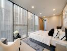 Modern bedroom with large windows and city view