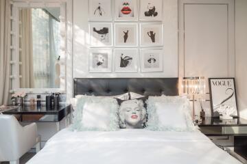 Well-lit bedroom with artistic decor