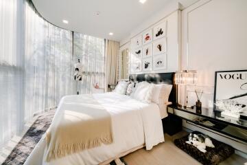 Bright, modern bedroom with large windows and stylish decor.