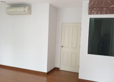 Interior of an empty room with wooden floor and air conditioning unit