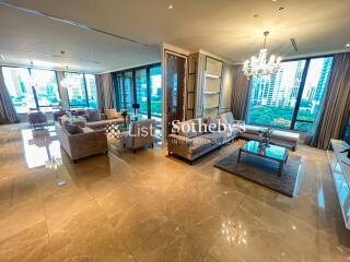 Spacious living room with modern furniture and large windows providing city views