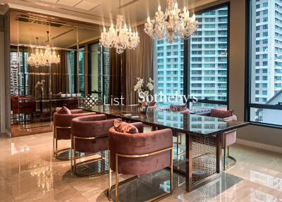 Elegant dining area with chandelier lighting and city view