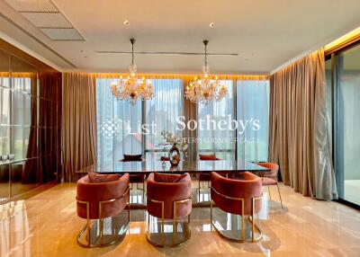 Elegant dining room with chandelier lights and large dining table.