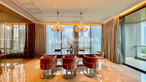 Elegant dining room with chandelier lights and large dining table.