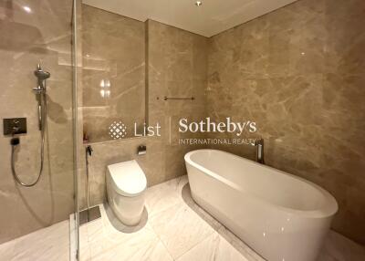 Luxurious bathroom with modern fixtures including a white bathtub and a shower area