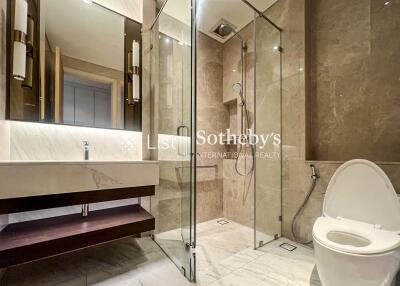 Modern bathroom with glass-enclosed shower and toilet