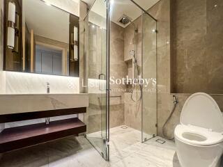 Modern bathroom with glass-enclosed shower and toilet