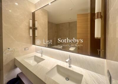 Modern bathroom with dual sinks and large mirror