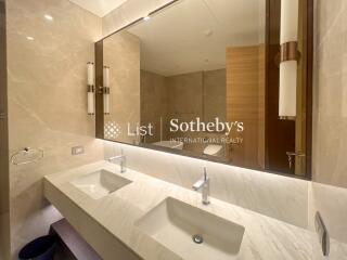 Modern bathroom with dual sinks and large mirror