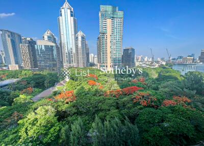 Scenic view of city buildings with lush greenery