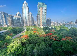 Scenic view of city buildings with lush greenery