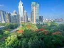 Scenic view of city buildings with lush greenery