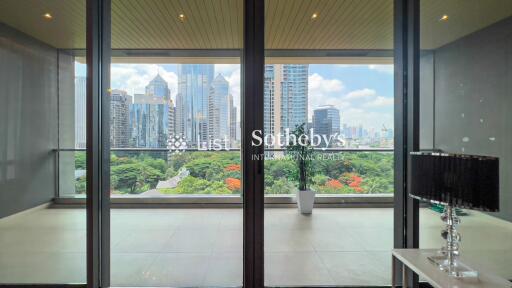 Living area with a large window offering a cityscape view