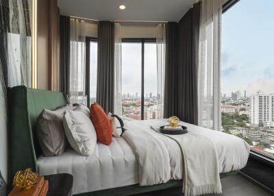 Modern bedroom with large windows and city view