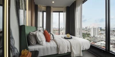 Modern bedroom with large windows and city view