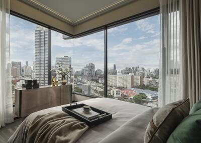 Bedroom with large windows and city view