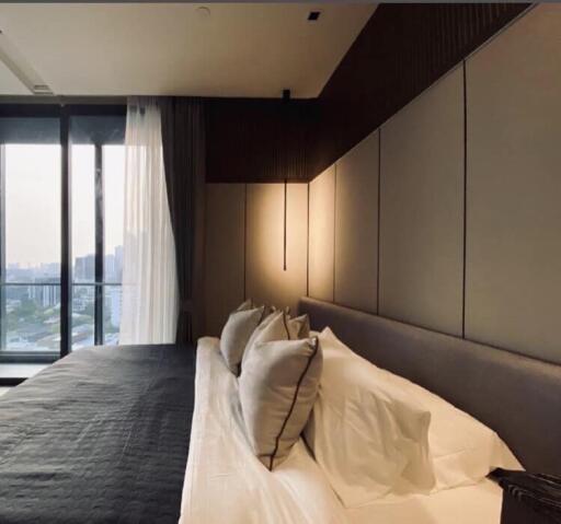 Modern bedroom with large bed and city view