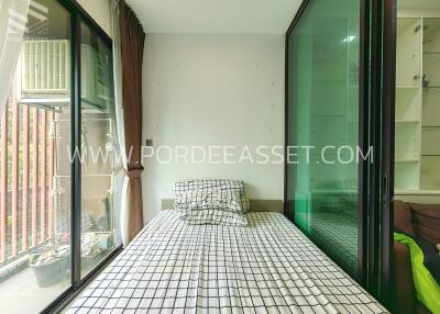 Small bedroom with large window and balcony access