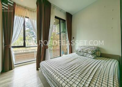 Spacious bedroom with large windows and balcony access