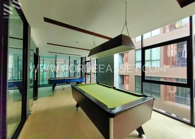 modern entertainment room with pool table and air hockey table