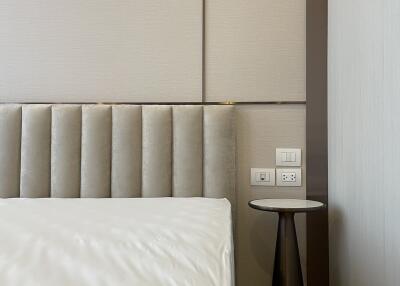 Modern bedroom with upholstered headboard and side table