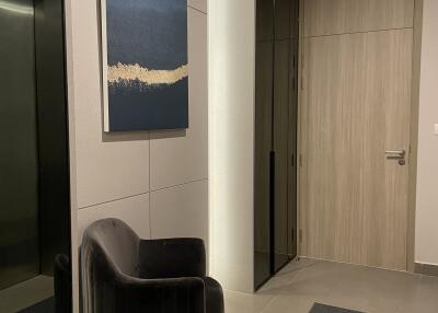 Modern hallway entrance with a chair and artwork