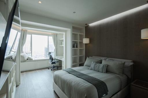 Modern bedroom with large window and built-in shelving