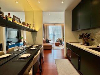 Modern kitchen and dining area opening to a cozy living room with large window