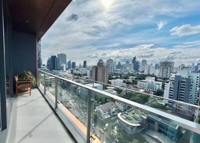 View of city skyline from balcony with glass railing