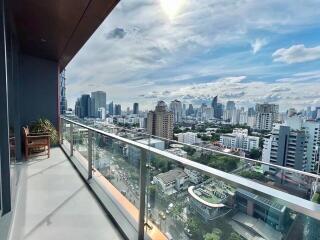 View of city skyline from balcony with glass railing