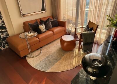 Cozy living room with brown sofa and round rug